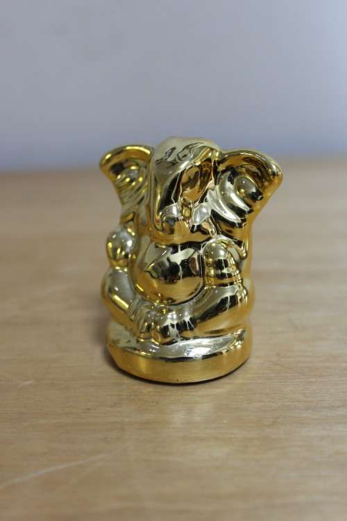Small little plastic/resin gold Elephant
