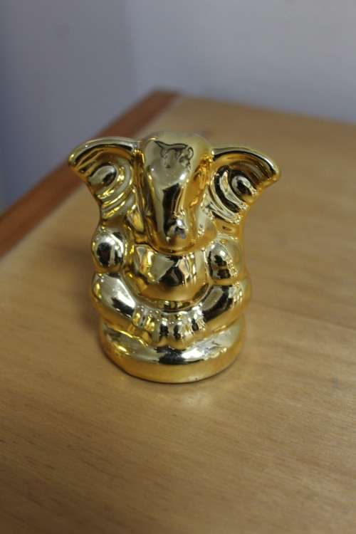 Small little plastic/resin gold Elephant