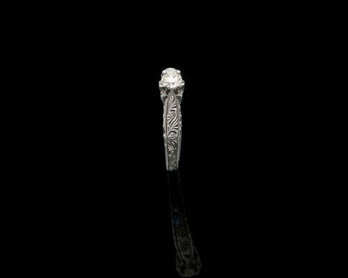 9ct, 3.2gr White Gold,0.27ct Round Brillant Diamond K SI1 with smalls on the band