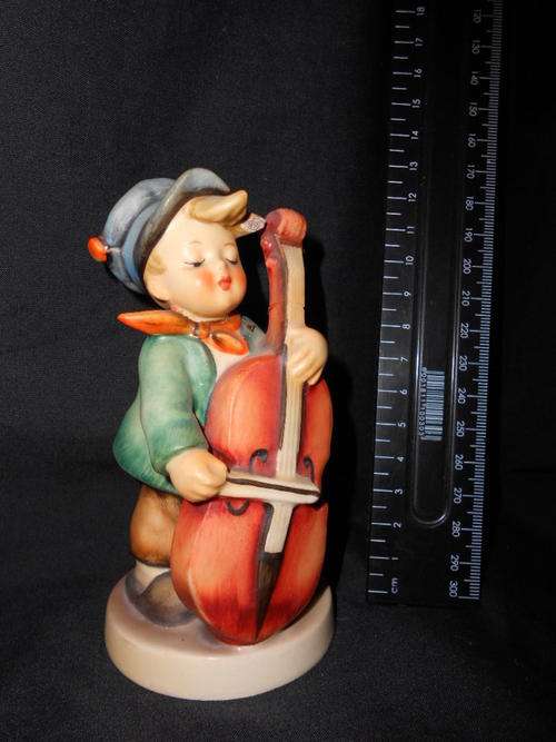 Hummel porcelain figurine, neck and instrument has been repaired - as per scan