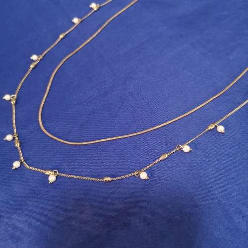 Layered strand chain necklace with hanging pearl detail