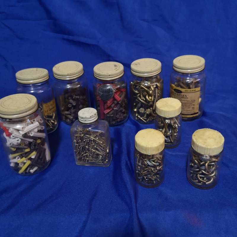 Vintage bottles with vintage brass hardware items. Ideal as garage decor or useable items