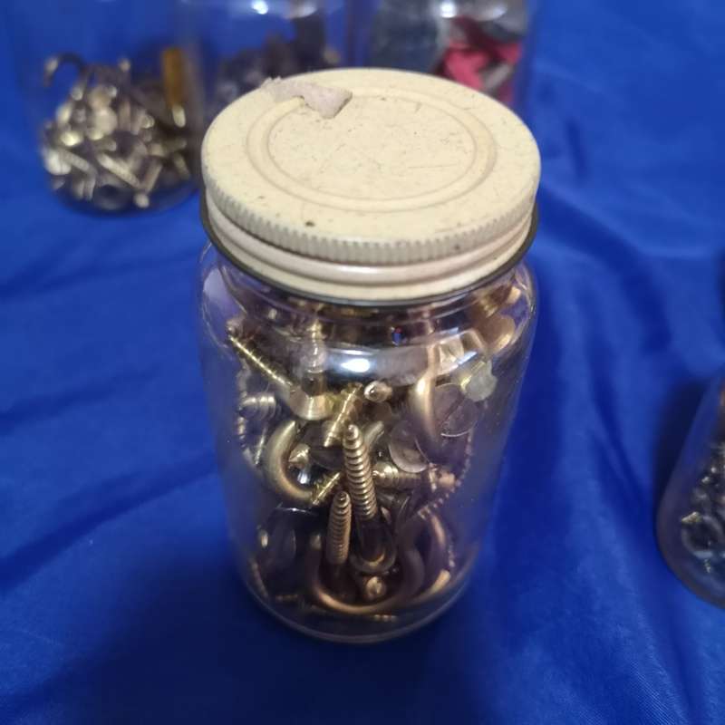 Vintage bottles with vintage brass hardware items. Ideal as garage decor or useable items