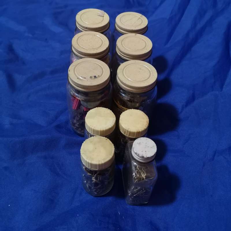 Vintage bottles with vintage brass hardware items. Ideal as garage decor or useable items