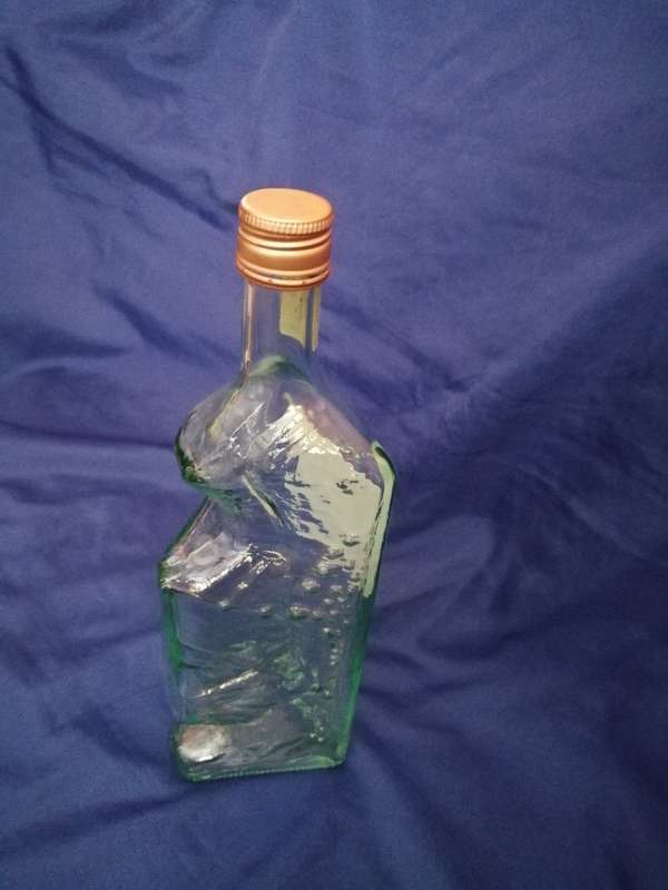 Table Mountain shaped glass bottle. Vintage item with lid and labelling