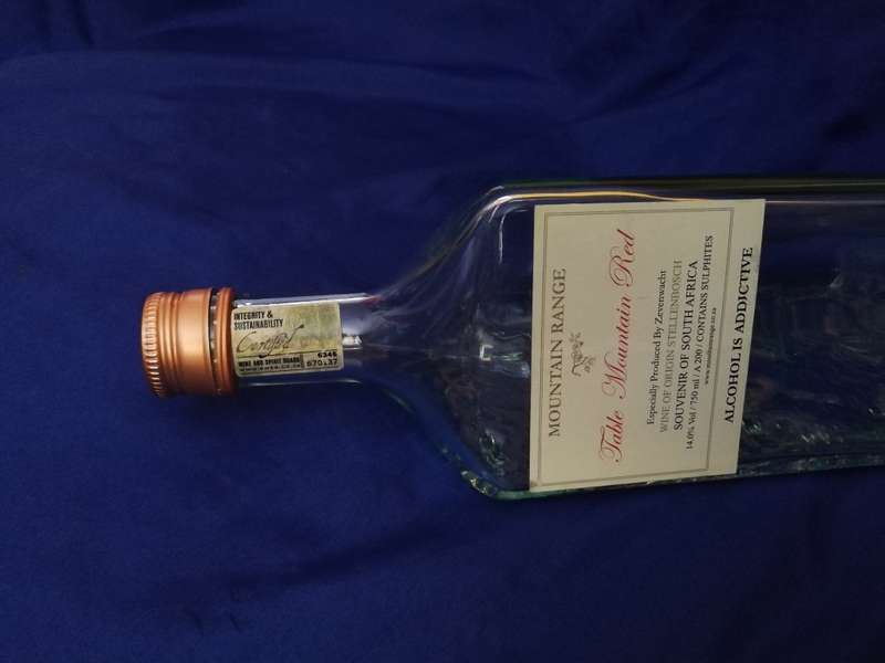 Table Mountain shaped glass bottle. Vintage item with lid and labelling