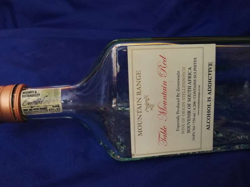 Table Mountain shaped glass bottle. Vintage item with lid and labelling