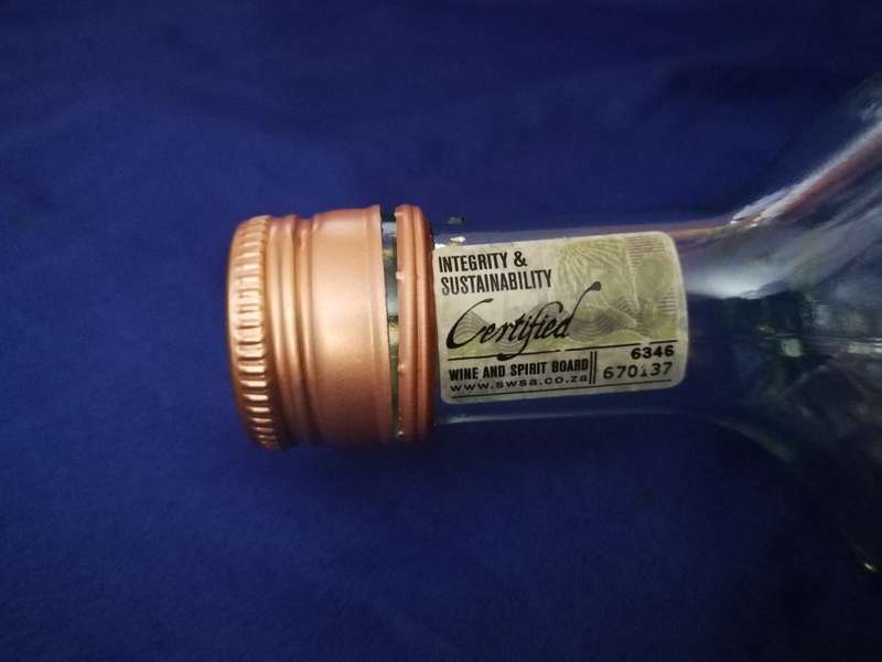 Table Mountain shaped glass bottle. Vintage item with lid and labelling