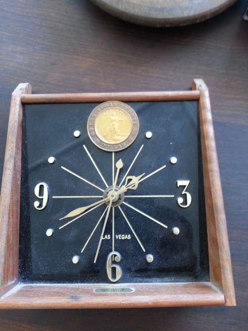 BEDSIDE CLOCK WITH OLD COIN ATTACHED