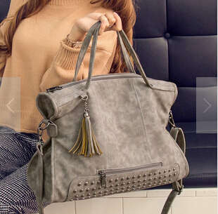 Large capacity rivets fashion ladies handbag. Grey color. Stock in ZA