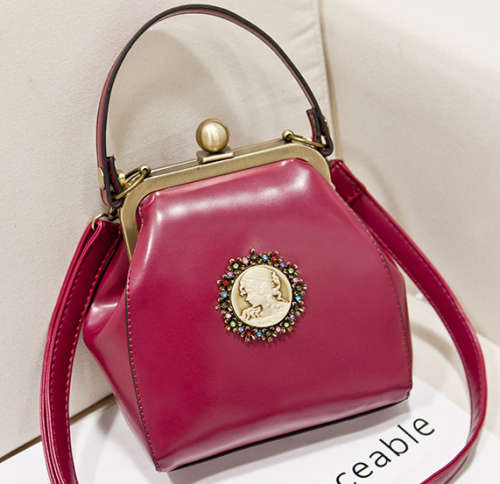 Vintage England style lesure handbag, with strape. Maroon color.