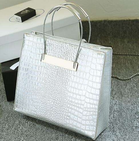 Crocodile pattern stereotyped fashion steel handle handbag. Grey color.