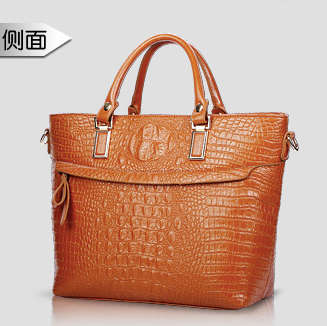 Elegant crocodile pattern ladies handbag with strape, brown color. Stock in ZA