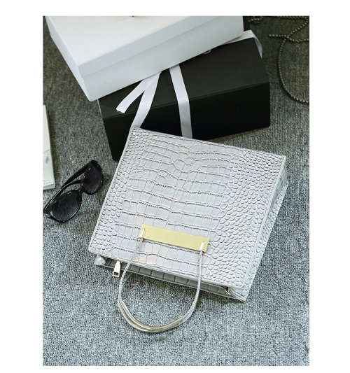 Crocodile pattern stereotyped fashion steel handle handbag. Grey color.