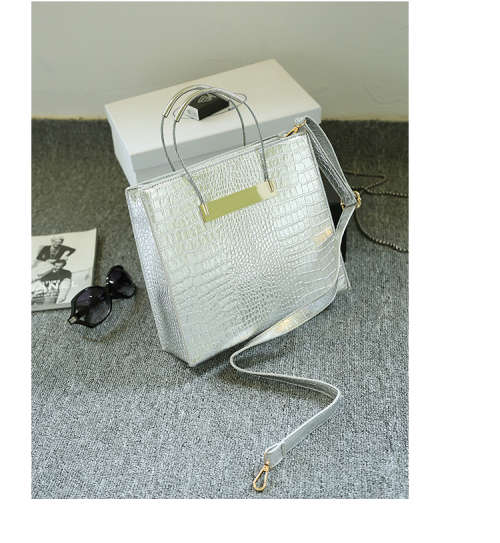 Crocodile pattern stereotyped fashion steel handle handbag. Grey color.