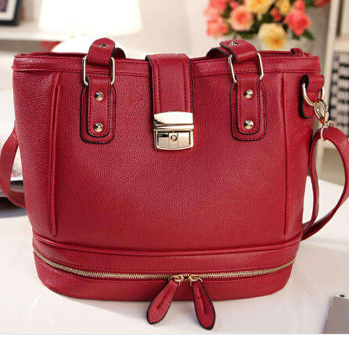 Zip in bottom style ladies handbag. Maroon color. Stock in ZA