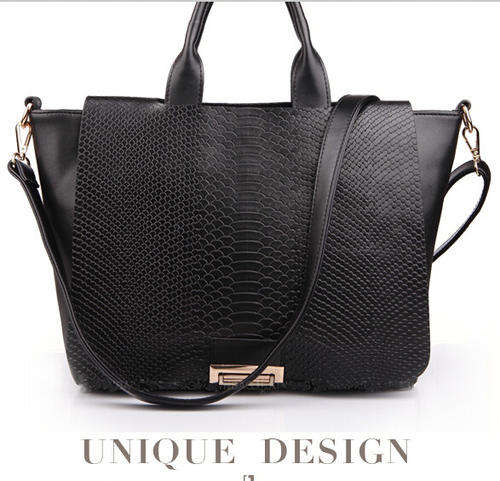 Elegant design snake pattern ladies handbag with strape. Black color.