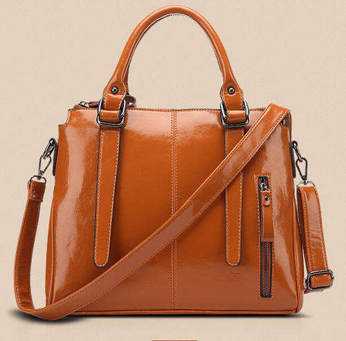 Smooth surface elegant consice ladies handbag with strape. Brown color. Stock in ZA