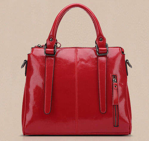 Smooth surface elegant consice ladies handbag with strape. Maroon color. Stock in ZA