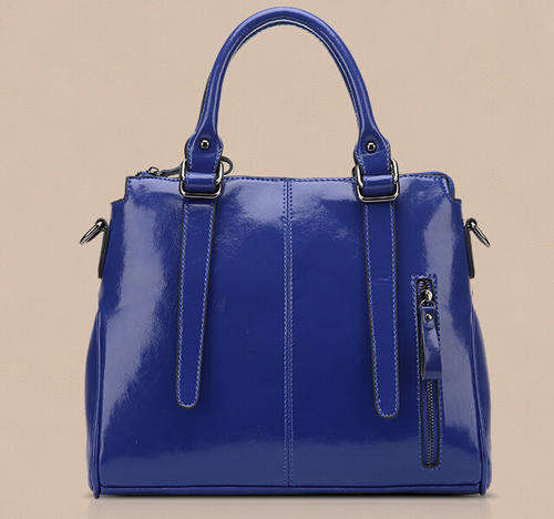 Smooth surface elegant consice ladies handbag with strape. Blue color. Stock in ZA