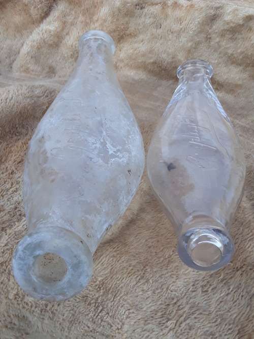 Two antique embossed glass baby feeding bottles Griptight