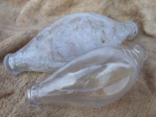 Two antique embossed glass baby feeding bottles Griptight