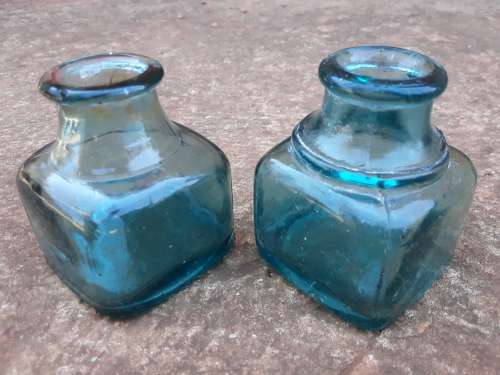 Two teal green ink bottles