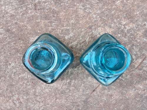 Two teal green ink bottles
