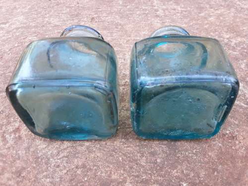 Two teal green ink bottles