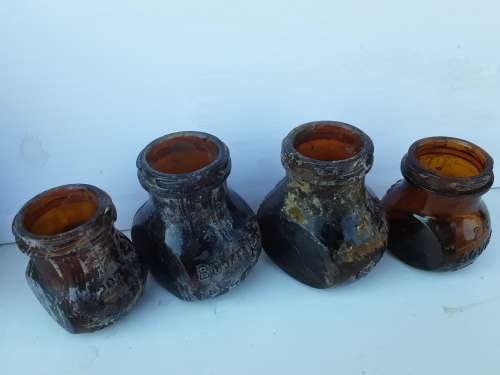Four Bovril bottles