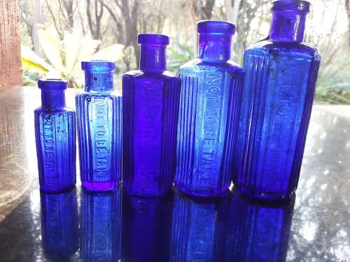 Five NOT TO BE TAKEN hexagonal cobalt blue bottles