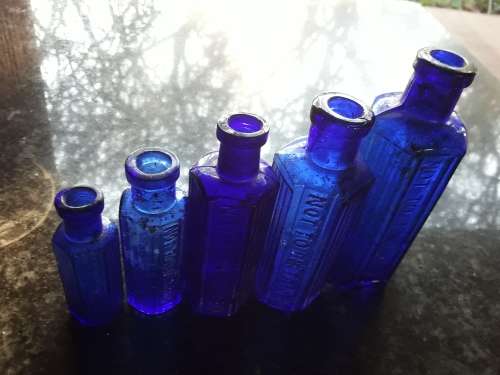 Five NOT TO BE TAKEN hexagonal cobalt blue bottles