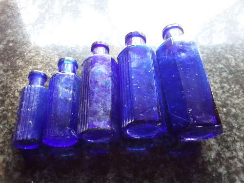 Five NOT TO BE TAKEN hexagonal cobalt blue bottles