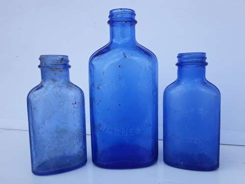 Light blue embossed MILK OF MAGNESIA vintage bottles