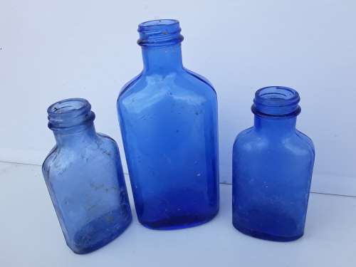 Light blue embossed MILK OF MAGNESIA vintage bottles