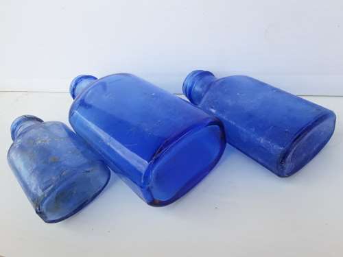 Light blue embossed MILK OF MAGNESIA vintage bottles