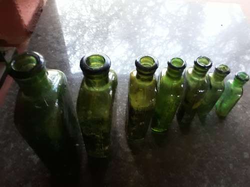 Seven green POISON NOT TO BE TAKEN bottles