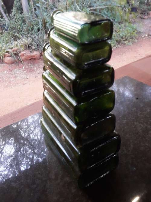 Seven green POISON NOT TO BE TAKEN bottles