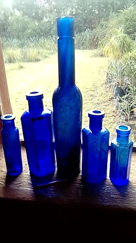 Five antique blue bottltes