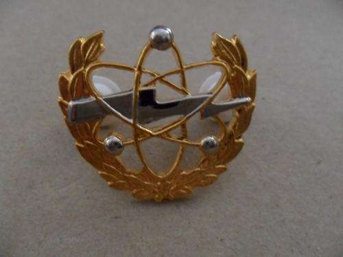 SAF Communications breast badge.