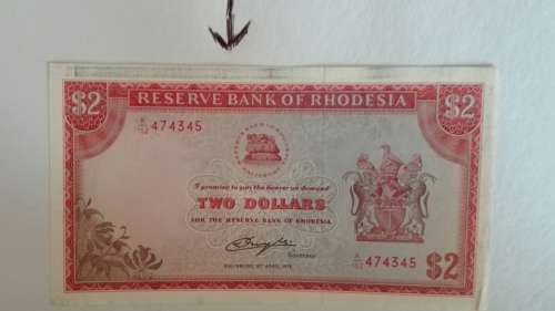 A Rhodesia bank note struck in error with a miss print of black ink as per pic. Very rare