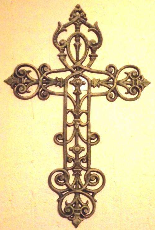 Large greenbrown metal cross with detailed design