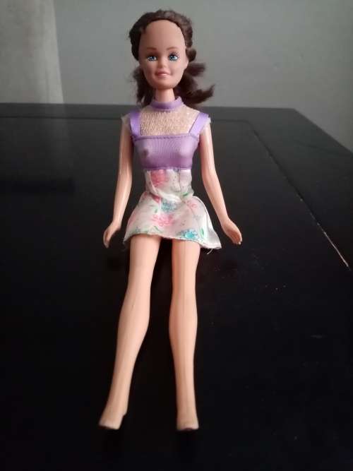 Barbie style doll purple and floral dress