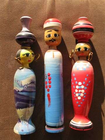 THREE EGYPTIAN PAINTED WOODEN DOLLS