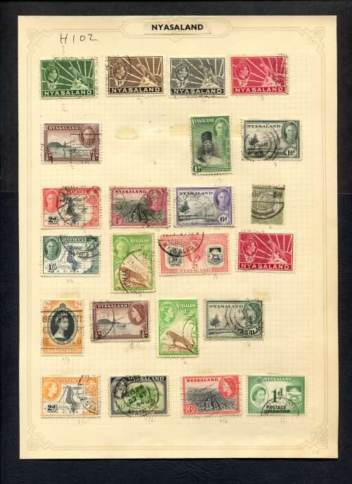 Nyasaland - 23 Stamps Mounted (Hinged) On Old Album Page