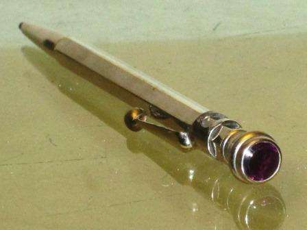 Antique made in England mechanical propelling pencil flush set with a purple stone