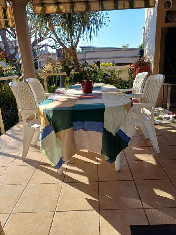 Plastic patio table plus four chairs