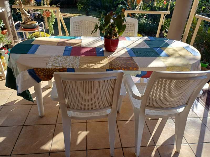 Plastic patio table plus four chairs