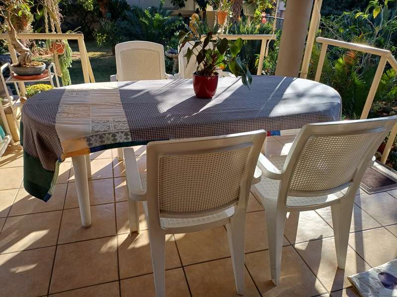 Plastic patio table plus four chairs