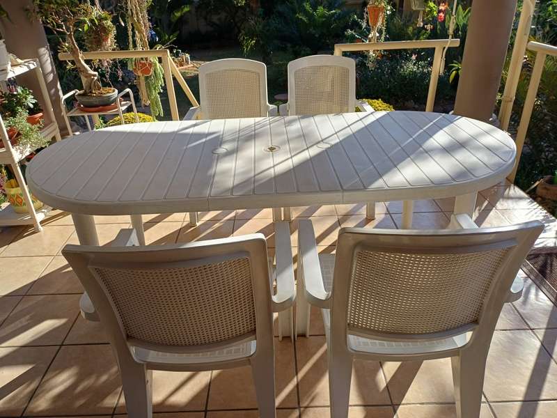 Plastic patio table plus four chairs